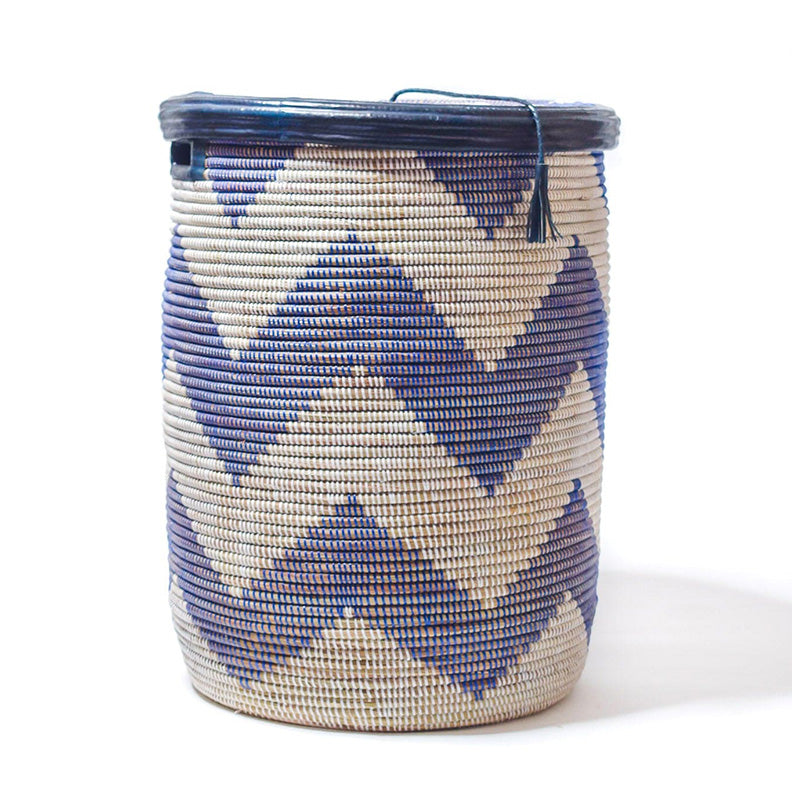 Large rounded woven basket with blue zig zag detail on white. Blue leather trim. Flat lid.