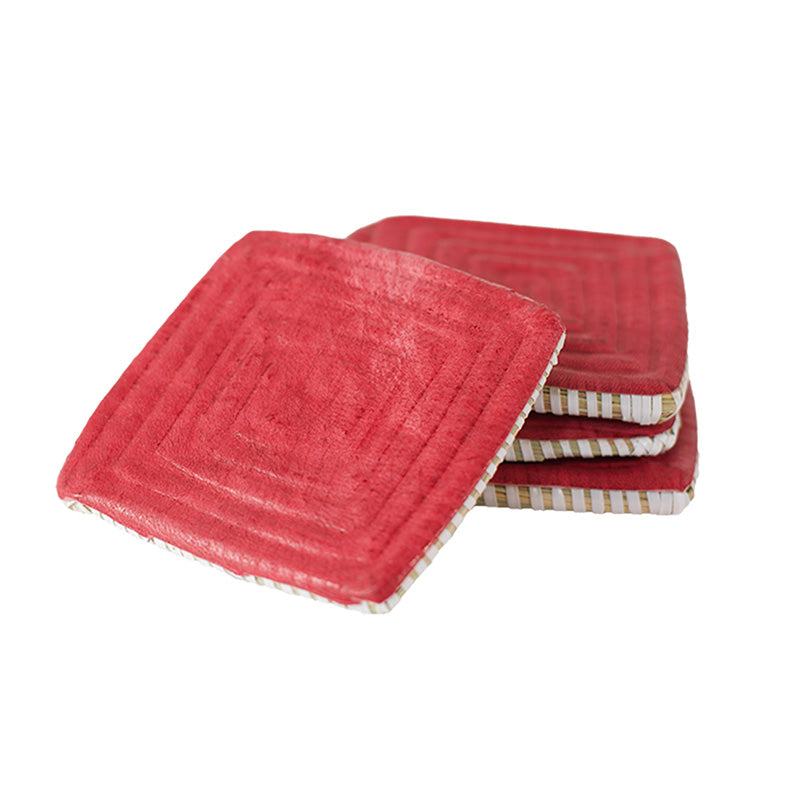 Square coaster stack on white. Woven and covered in red leather.