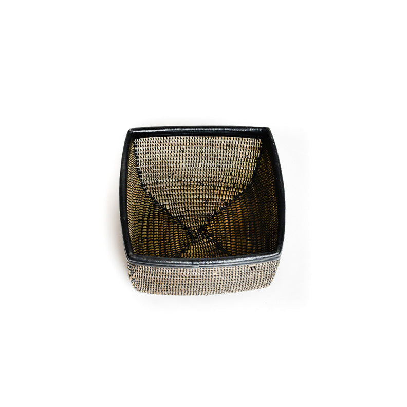 Busso basket on white. A square woven basket with black detail including a black leather trim. View is from the top.